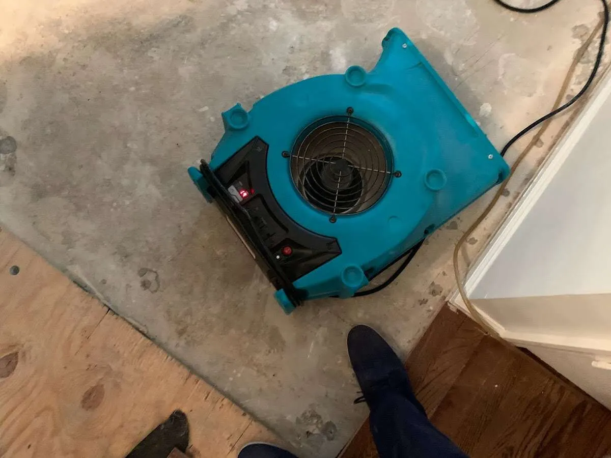 Air mover drying subfloor during Commercial Water Damage Restoration in Louisville